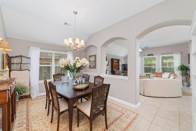28035 Emma Gardens Ln, Spring, TX 77386 - dining space featuring lofted ceiling, a chandelier, light tile patterned floors, arched walkways, and a ceiling fan