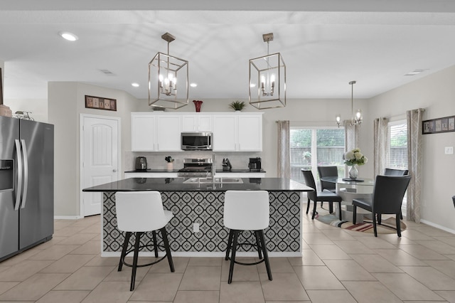 2803 Ridgecliff Ct, Conroe, TX 77301 - kitchen with stainless steel appliances, a chandelier, dark countertops, a kitchen breakfast bar, and backsplash