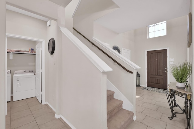 2803 Ridgecliff Ct, Conroe, TX 77301 - entrance foyer with washer and dryer, stairway, and light tile patterned flooring