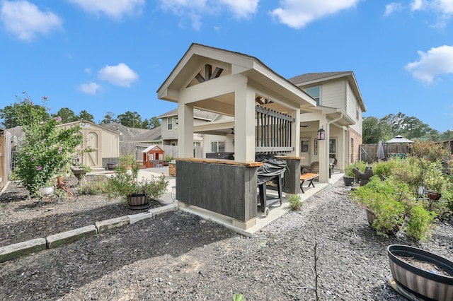 2803 Ridgecliff Ct, Conroe, TX 77301 - rear view of property featuring a patio, a storage unit, and a fenced backyard