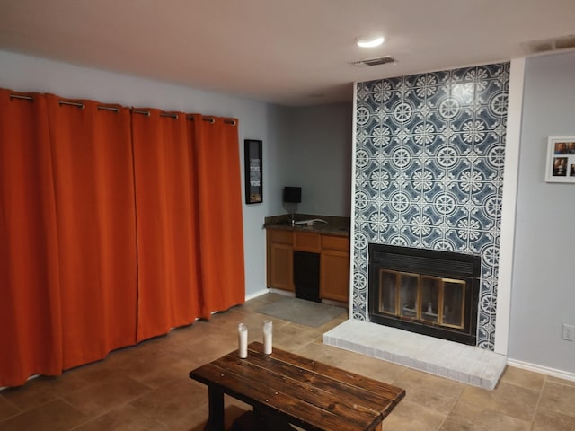 3125 Hells Gate Loop Unit 29, Strawn, TX 76475 - tiled living area with a glass covered fireplace and baseboards