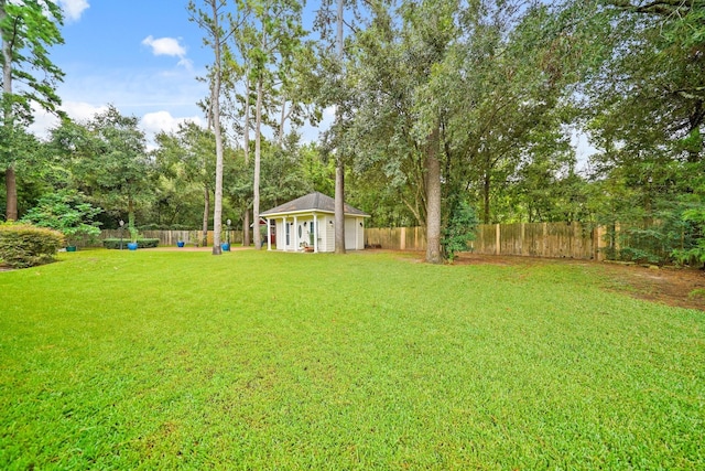 6107 Kyle Bend Ln, Katy, TX 77493 - fenced backyard featuring an outbuilding and view of scattered trees