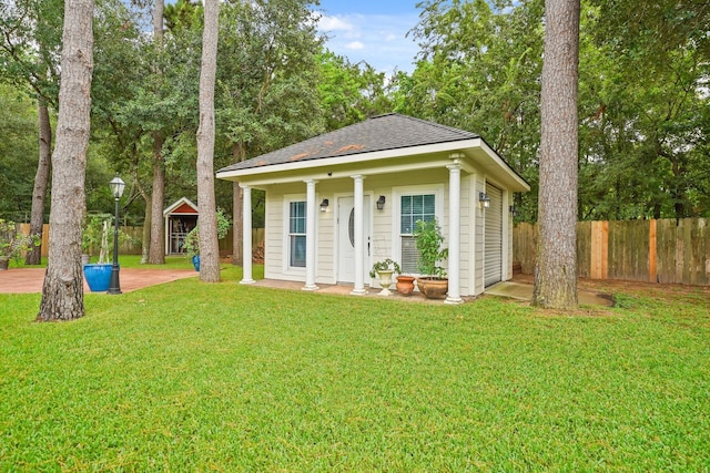 6107 Kyle Bend Ln, Katy, TX 77493 - view of front of home featuring a fenced backyard, an outbuilding, and a shingled roof