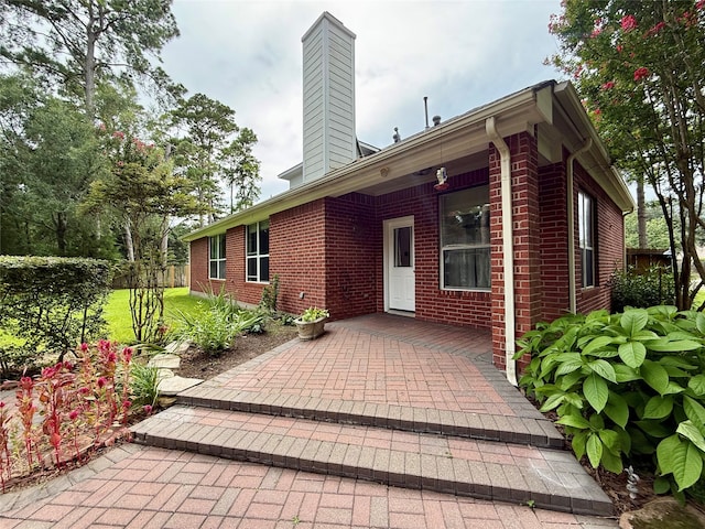 6107 Kyle Bend Ln, Katy, TX 77493 - back of house featuring brick siding and a chimney
