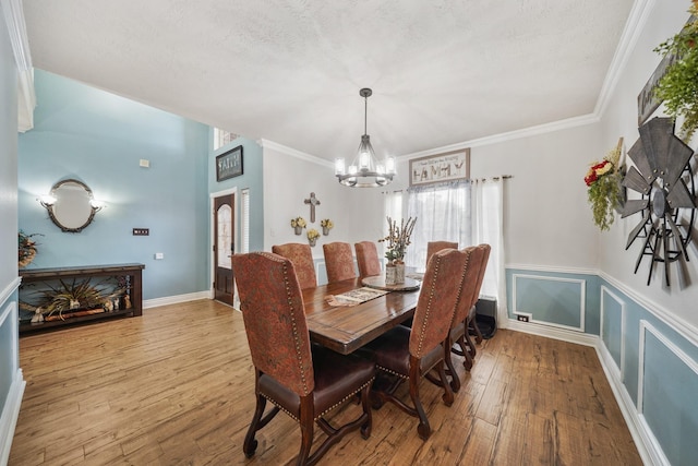6107 Kyle Bend Ln, Katy, TX 77493 - dining room with a chandelier, wood finished floors, and ornamental molding