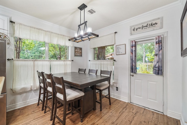 6107 Kyle Bend Ln, Katy, TX 77493 - dining area with ornamental molding and light wood-style floors