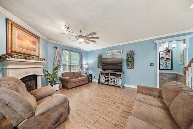 6107 Kyle Bend Ln, Katy, TX 77493 - living room featuring a ceiling fan, light wood-type flooring, a fireplace, ornamental molding, and stairway