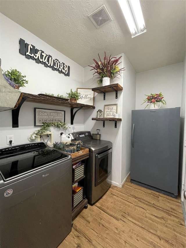 6107 Kyle Bend Ln, Katy, TX 77493 - kitchen featuring freestanding refrigerator, washing machine and dryer, light wood-style flooring, and open shelves