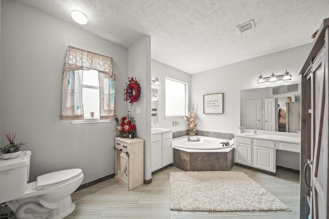 6107 Kyle Bend Ln, Katy, TX 77493 - full bath featuring a bath, two vanities, and a textured ceiling