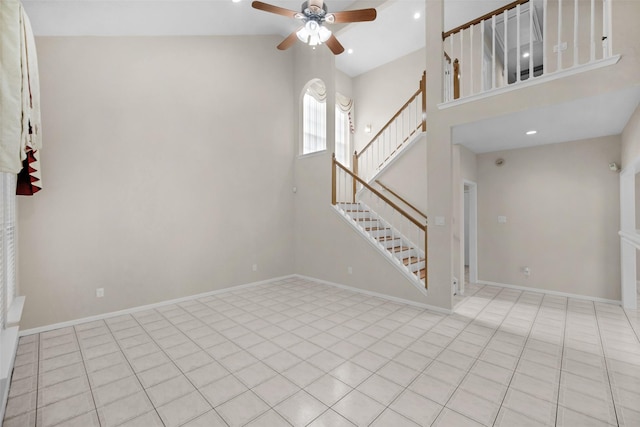 13535 San Martin Ln, Houston, TX 77083 - unfurnished living room featuring ceiling fan, stairway, recessed lighting, a towering ceiling, and tile patterned floors