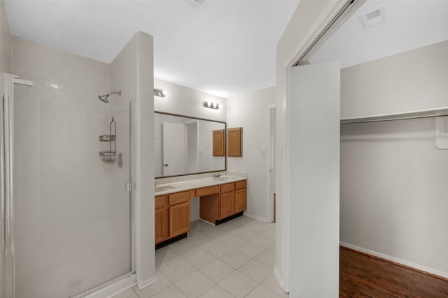13535 San Martin Ln, Houston, TX 77083 - full bathroom featuring a stall shower, double vanity, a spacious closet, and tile patterned floors