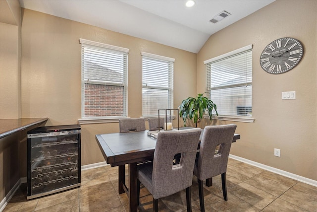 213 Lighthouse Bay Ln, League City, TX 77539 - dining area with beverage cooler, lofted ceiling, and light tile patterned floors
