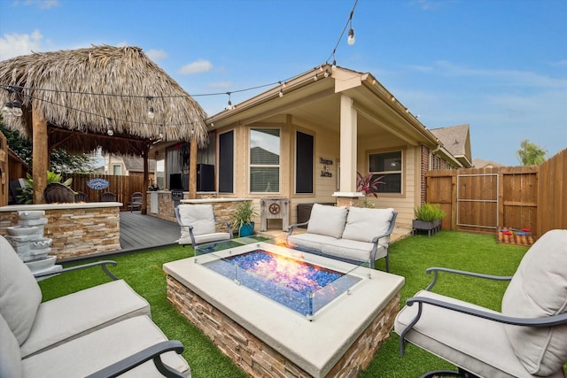 213 Lighthouse Bay Ln, League City, TX 77539 - back of property featuring an outdoor living space with a fire pit and a deck
