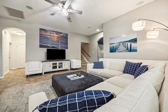 213 Lighthouse Bay Ln, League City, TX 77539 - living room with arched walkways, a ceiling fan, tile patterned flooring, stairway, and recessed lighting