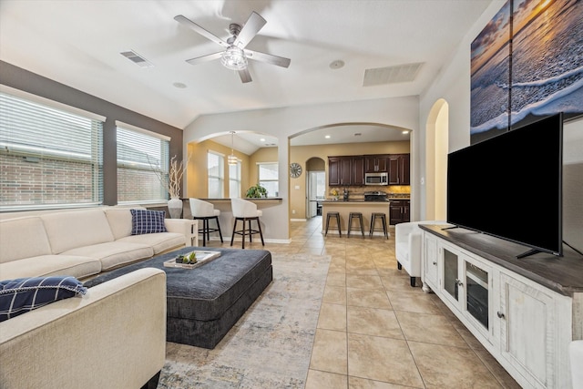 213 Lighthouse Bay Ln, League City, TX 77539 - living area featuring a ceiling fan, arched walkways, light tile patterned floors, lofted ceiling, and recessed lighting