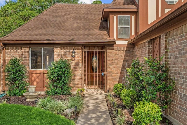 8411 Lylewood Ct, Houston, TX 77040 - doorway to property featuring a shingled roof and brick siding
