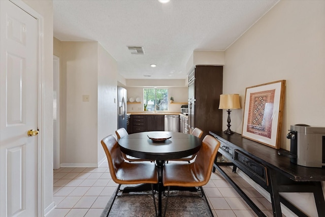 8411 Lylewood Ct, Houston, TX 77040 - dining room with light tile patterned flooring and a textured ceiling