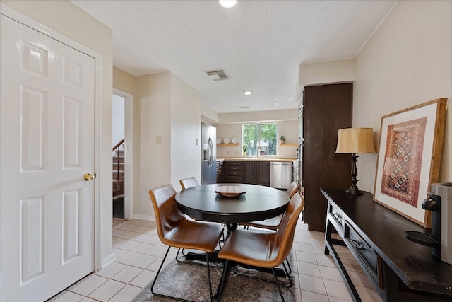 8411 Lylewood Ct, Houston, TX 77040 - dining area featuring light tile patterned flooring, stairs, a textured ceiling, and recessed lighting
