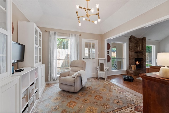 8411 Lylewood Ct, Houston, TX 77040 - sitting room featuring lofted ceiling, healthy amount of natural light, a fireplace, and a chandelier