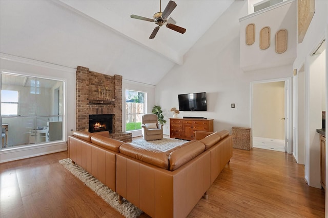 8411 Lylewood Ct, Houston, TX 77040 - living area with light wood-style flooring, high vaulted ceiling, a ceiling fan, a fireplace, and beamed ceiling