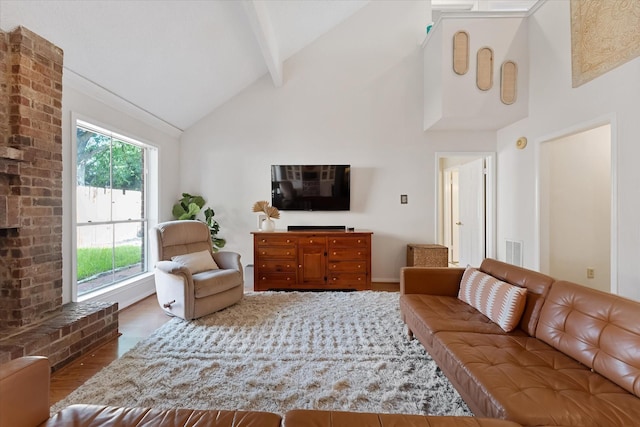 8411 Lylewood Ct, Houston, TX 77040 - living room with high vaulted ceiling, wood finished floors, beamed ceiling, and a brick fireplace