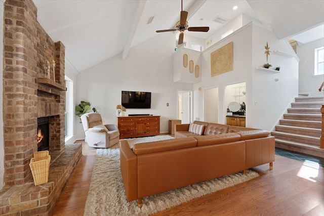 8411 Lylewood Ct, Houston, TX 77040 - living area featuring wood finished floors, beam ceiling, a ceiling fan, a fireplace, and stairway