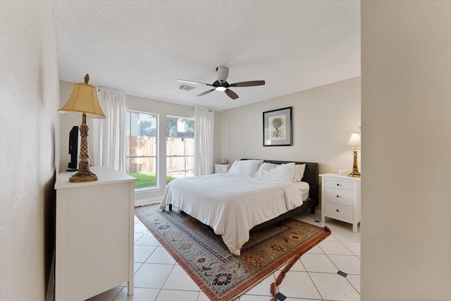 8411 Lylewood Ct, Houston, TX 77040 - bedroom featuring light tile patterned floors, a textured ceiling, and ceiling fan