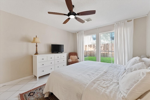 8411 Lylewood Ct, Houston, TX 77040 - bedroom featuring access to outside, light tile patterned floors, a ceiling fan, and a textured ceiling