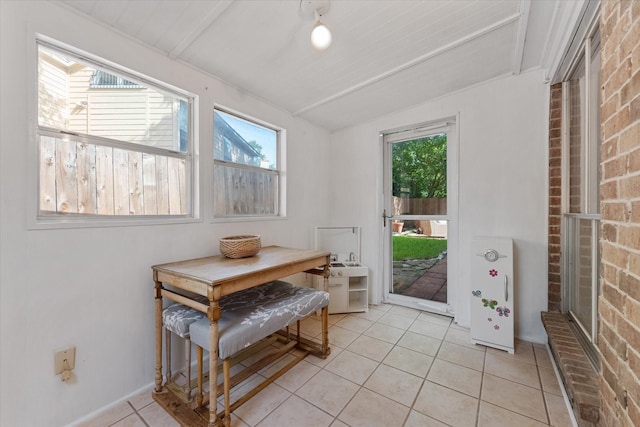8411 Lylewood Ct, Houston, TX 77040 - doorway to outside with healthy amount of natural light, light tile patterned floors, and brick wall
