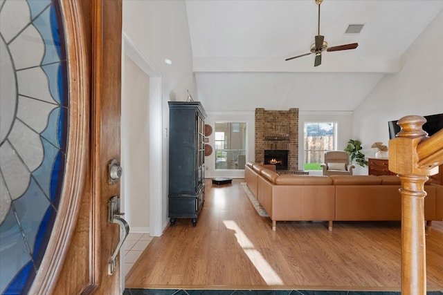 8411 Lylewood Ct, Houston, TX 77040 - living room with lofted ceiling, a ceiling fan, a fireplace, and light wood-style flooring