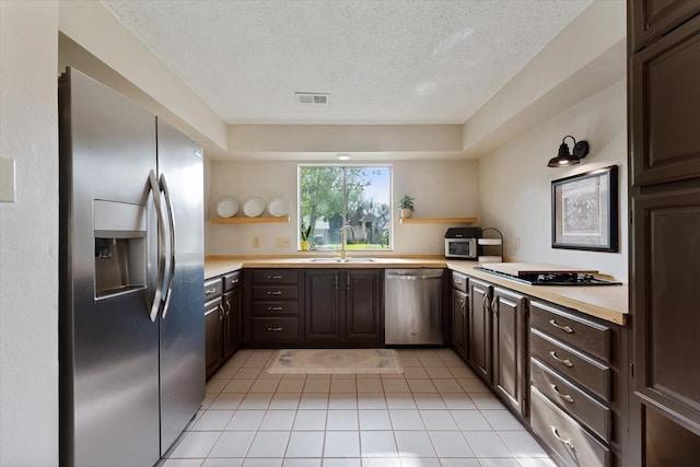 8411 Lylewood Ct, Houston, TX 77040 - kitchen with appliances with stainless steel finishes, light countertops, light tile patterned flooring, dark brown cabinets, and a textured ceiling