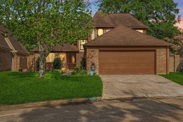 8411 Lylewood Ct, Houston, TX 77040 - view of front of property featuring driveway, a front lawn, an attached garage, roof with shingles, and brick siding