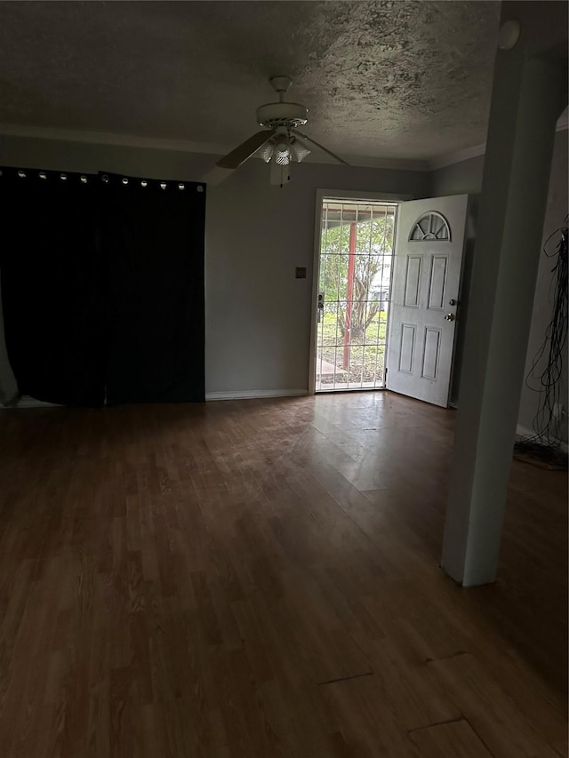 4730 Angleton St, Houston, TX 77033 - unfurnished living room with ceiling fan, wood finished floors, and a textured ceiling