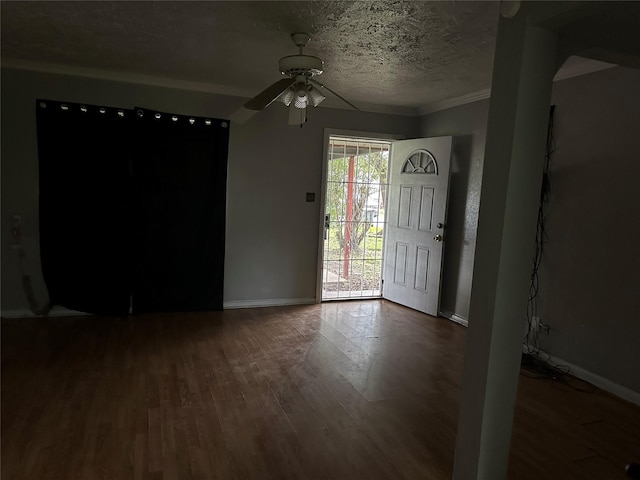 4730 Angleton St, Houston, TX 77033 - foyer featuring dark wood finished floors, a ceiling fan, a textured ceiling, and crown molding
