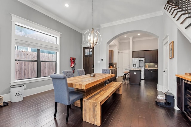 5825 Petty St, Houston, TX 77007 - dining area with arched walkways, dark wood-type flooring, crown molding, a chandelier, and recessed lighting