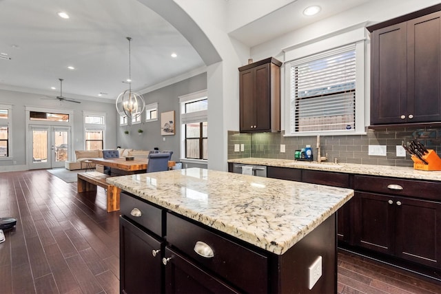 5825 Petty St, Houston, TX 77007 - kitchen with dark wood-style floors, a kitchen island, tasteful backsplash, open floor plan, and arched walkways