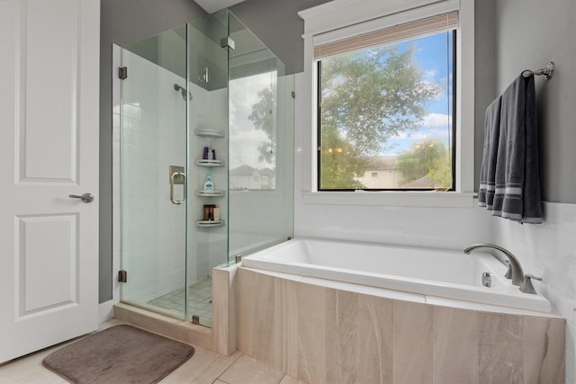 5825 Petty St, Houston, TX 77007 - full bathroom with a shower stall, a garden tub, and tile patterned floors