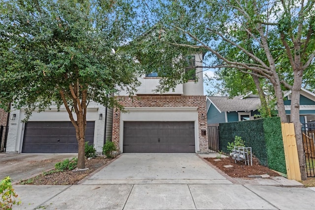 5825 Petty St, Houston, TX 77007 - view of front of home with concrete driveway, brick siding, and an attached garage