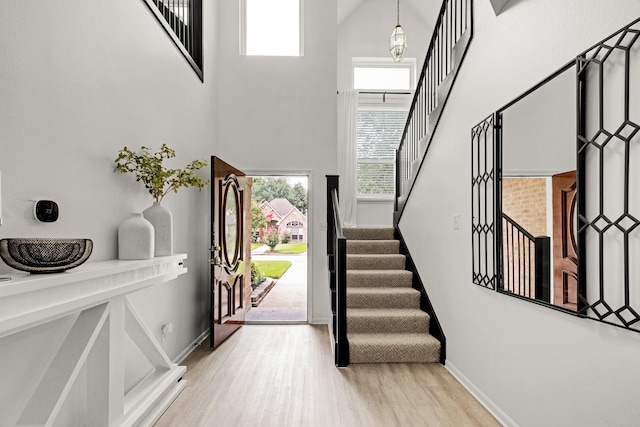 10603 Wagon Trail Rd, Houston, TX 77064 - foyer entrance featuring a high ceiling, stairway, and light wood-type flooring