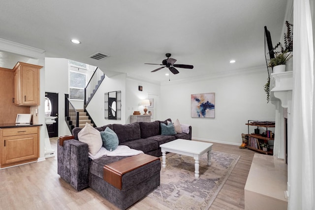 10603 Wagon Trail Rd, Houston, TX 77064 - living room with light wood-type flooring, stairs, a ceiling fan, a fireplace, and recessed lighting