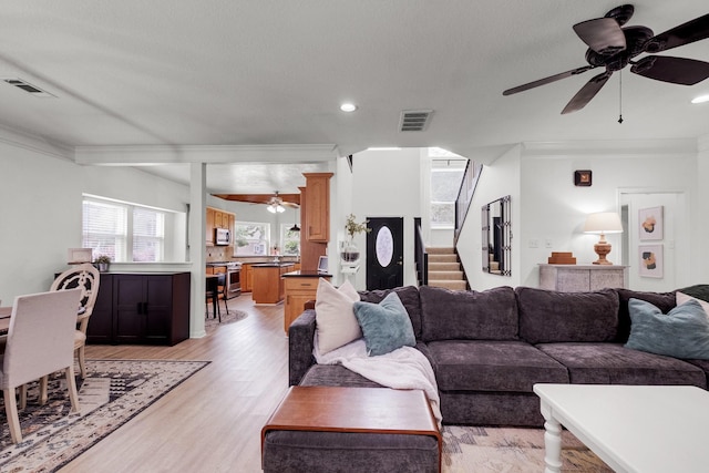 10603 Wagon Trail Rd, Houston, TX 77064 - living room featuring a ceiling fan, crown molding, stairway, light wood-type flooring, and recessed lighting