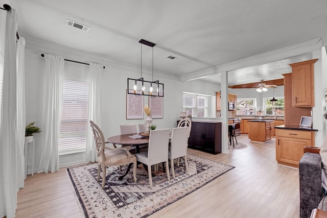 10603 Wagon Trail Rd, Houston, TX 77064 - dining area featuring light wood-style floors, a chandelier, ornamental molding, and ceiling fan