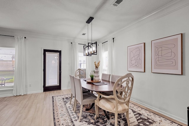 10603 Wagon Trail Rd, Houston, TX 77064 - dining area with a chandelier, light wood finished floors, and crown molding