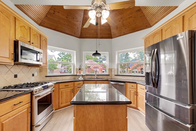10603 Wagon Trail Rd, Houston, TX 77064 - kitchen with appliances with stainless steel finishes, wooden ceiling, light wood-type flooring, dark stone countertops, and a kitchen island