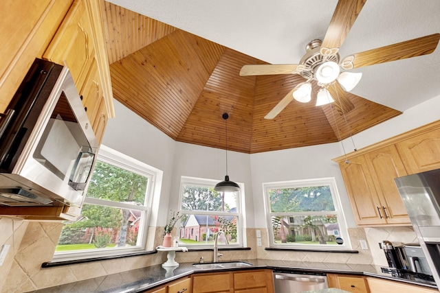 10603 Wagon Trail Rd, Houston, TX 77064 - kitchen featuring dark countertops, stainless steel appliances, backsplash, light brown cabinetry, and pendant lighting