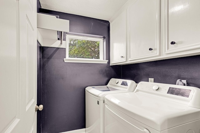 10603 Wagon Trail Rd, Houston, TX 77064 - laundry area featuring washing machine and clothes dryer and cabinet space