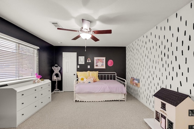 10603 Wagon Trail Rd, Houston, TX 77064 - carpeted bedroom featuring an accent wall, wallpapered walls, and ceiling fan