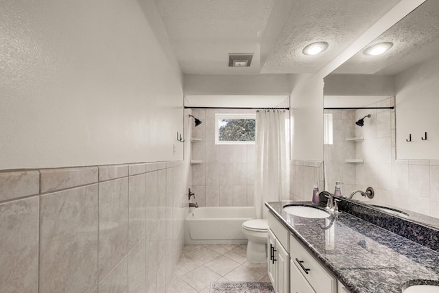 10603 Wagon Trail Rd, Houston, TX 77064 - bathroom featuring tile walls, a textured ceiling, shower / tub combo, tile patterned flooring, and double vanity