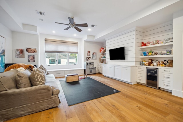 3835 Merrick St, Houston, TX 77025 - living area with beverage cooler, light wood finished floors, ceiling fan, and recessed lighting