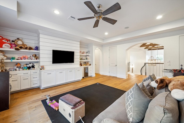 3835 Merrick St, Houston, TX 77025 - living area featuring arched walkways, light wood-type flooring, a ceiling fan, beverage cooler, and recessed lighting